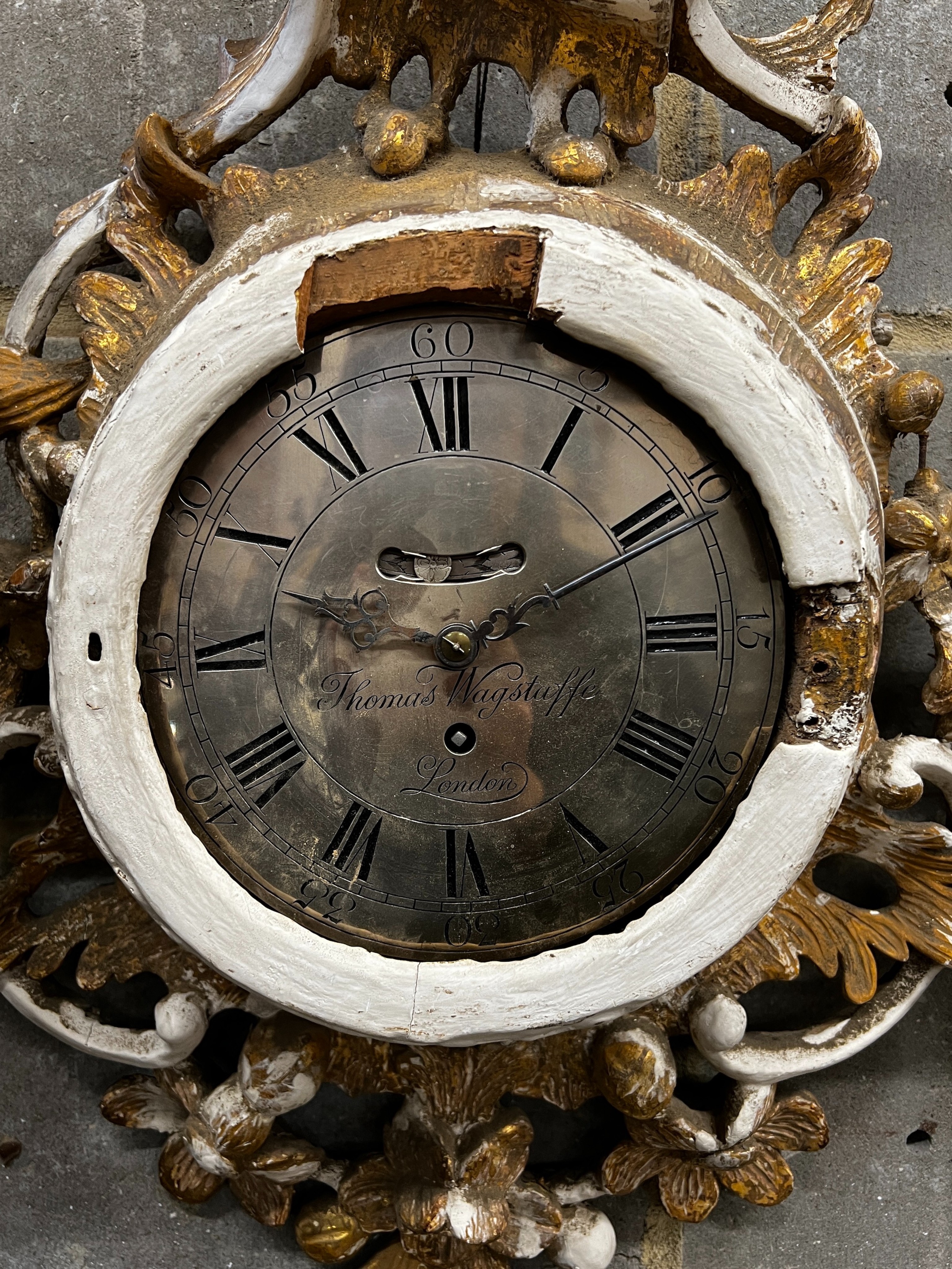 An early 19th century carved giltwood single fusee wall timepiece, silvered dial marked Thomas Wagstaffe, London. Case in need of restoration, height 78cm